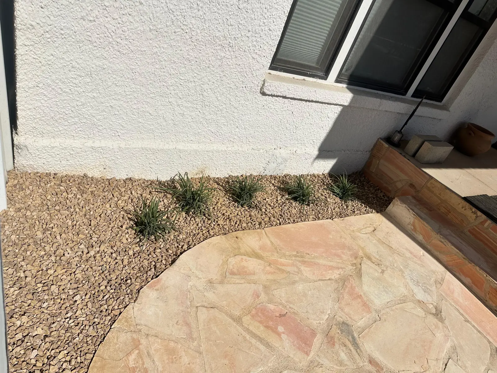 Flagstone paving and gravel planting beds beside the N 7th Street residence