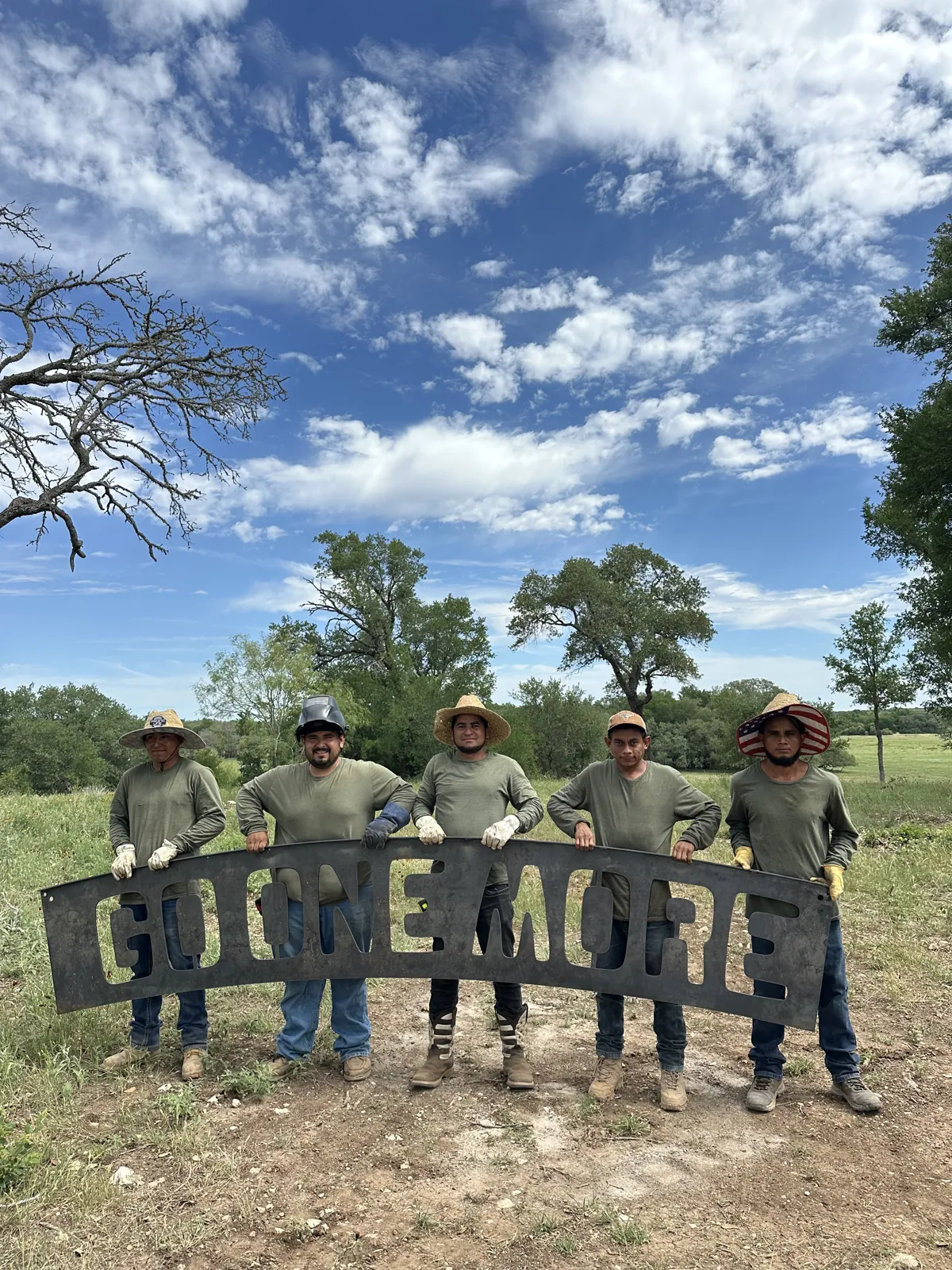 The crew with the custom Go One More sign.