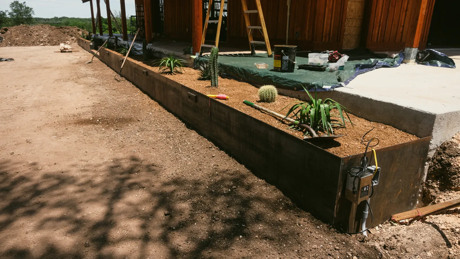 During construction: steel-edged planting beds along the ranch building.